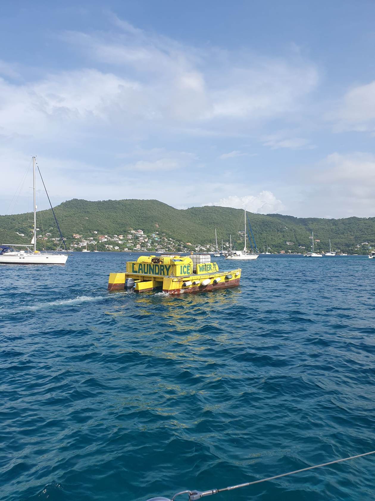 Gelbes Versorgungsboot in einer Ankerbucht in der Karibik